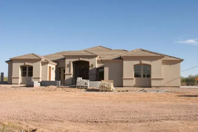 Custom home construction in a suburban area showcases modern design and attention to detail